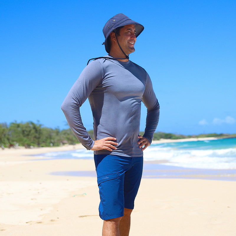 Man on the beach in UV Skinz's board shorts|dark-navy