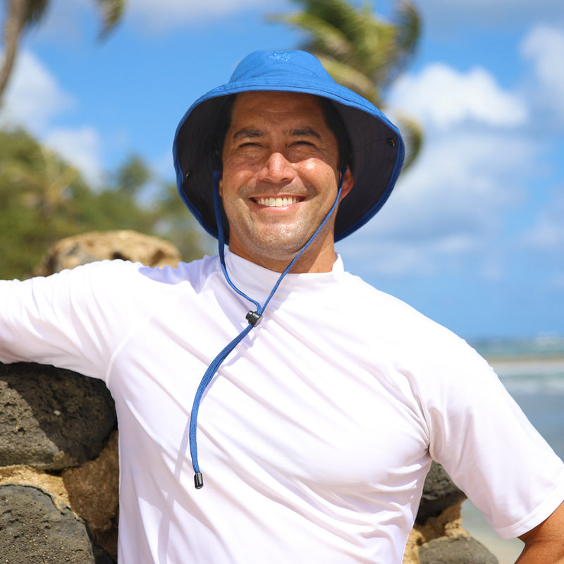 Man in UV Skinz's men's bucket hat with drawstring in washed navy charcoal|washed-navy-charcoal