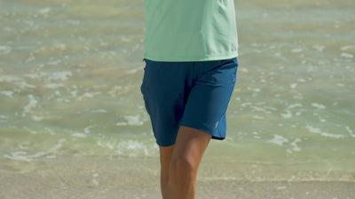 Woman Stretching in the Sun in Her Favorite UV Skinz's Women's Board Shorts