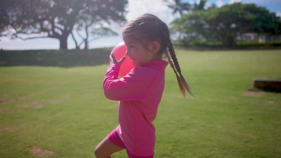 Kids playing outside in UV Skinz's kid's long sleeve swim shirts