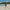 Man walking on the beach in UV Skinz's men's coastal board shorts