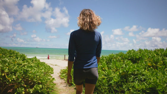 Woman in UV Skinz's Women's V-Neck Sun & Swim Shirt Wading Through the Water