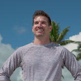 Man on the beach in UV Skinz's men's board shorts 