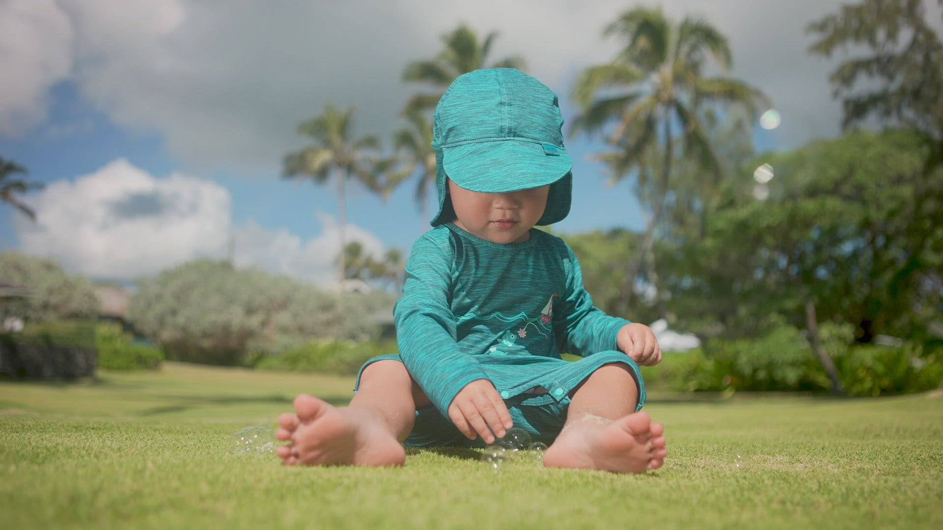 Baby Boy Playing with Bubbles in UV Skinz's Baby Boy's Swim Flap Hat